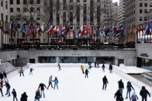 a group of people ice skating at Rockefeller Center