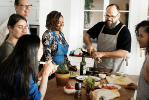 a group of people preparing food in a kitchen