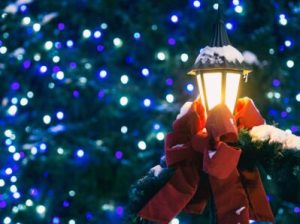 a holiday light pole decorate with a bow