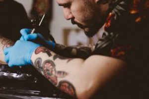 a man tattooing someone
