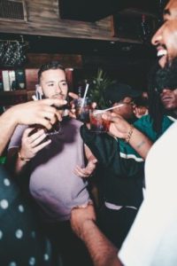 guys toasting at a bar