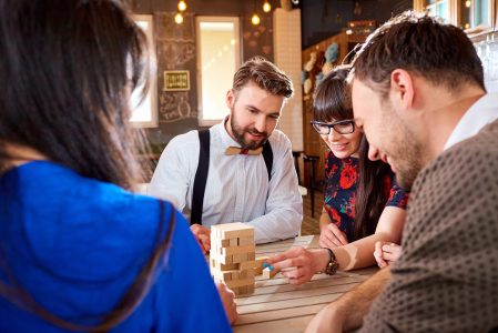 Friends play board games at the table.