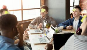 Group of co-workers with sticky notes on their foreheads