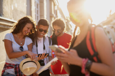 a group of people looking at something on a phone