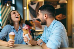 leisure and people concept - happy friends eating and drinking at barbecue party on rooftop