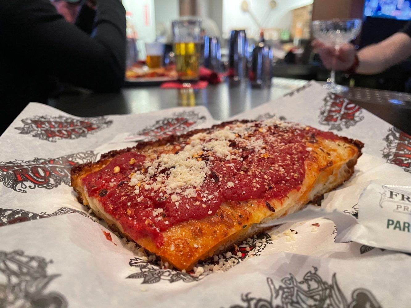 a piece of cake with a slice of pizza on a paper plate