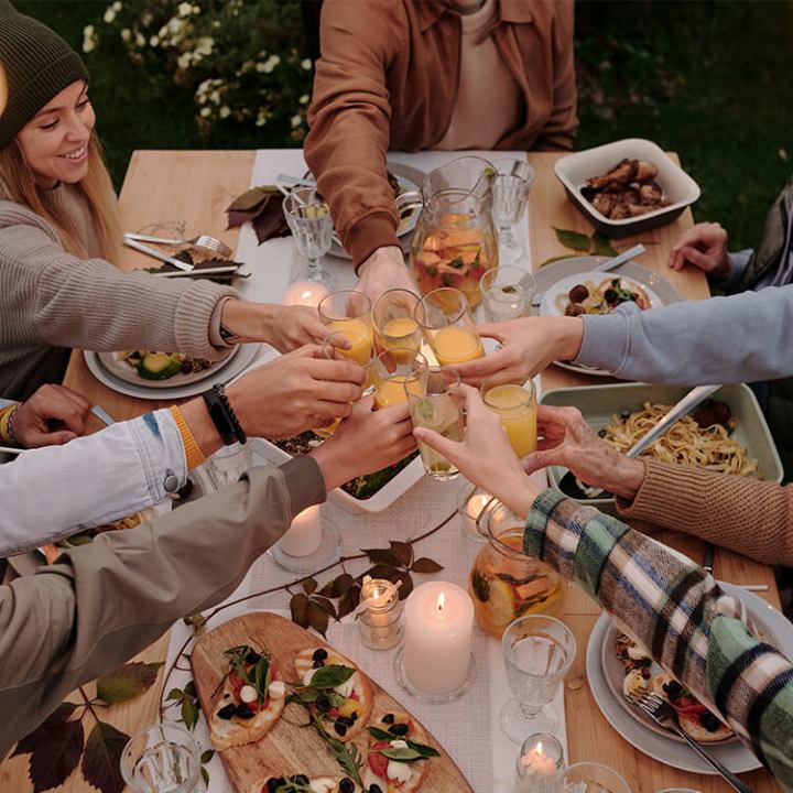 a group of people sitting on a cutting board with a cake