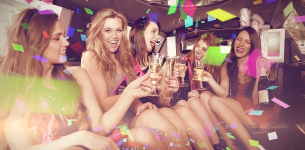 Girls on a bachelorette party in a limo with drinks