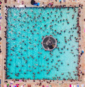 People Swimming in a busy Pool