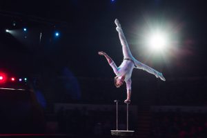 Man's aerial acrobatics in the Circus - one-handed handstand