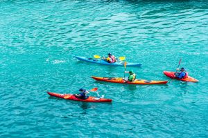 a group of people on kayaks is bright crystal blue, clear waters