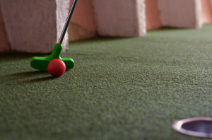 a close up of a putt putt club and ball
