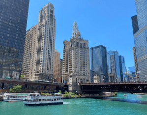 Boats cruising around through skyscrapers for architecture tour in Chicago