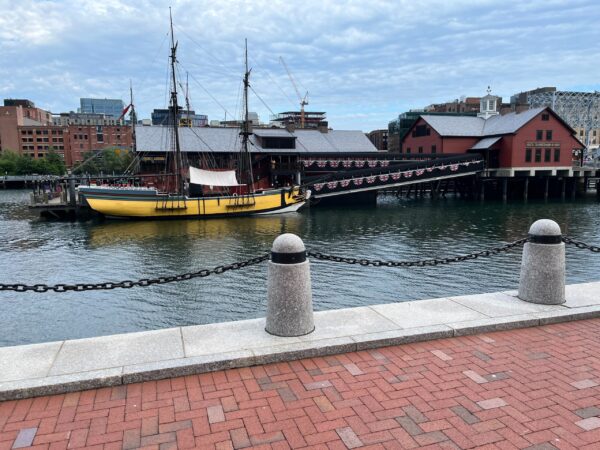 a boat is docked next to a body of water