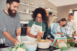 a group of people sitting at a table with a plate of food