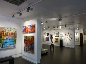 inside an art gallery with colorful acrylic paintings