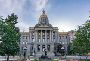 a statue in front of Colorado State Capitol