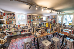 a room filled with furniture and a book shelf