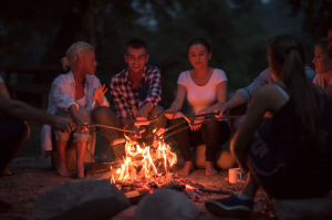 a group of people sitting around a fire