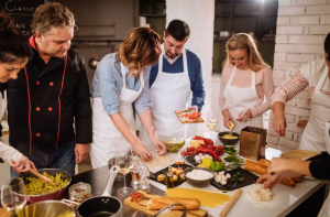 a group of people preparing food on a table