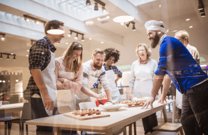 a group of people standing around a table