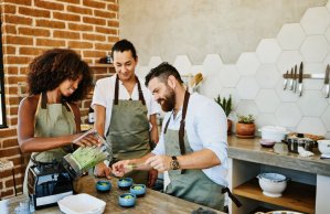 a man and woman preparing food in a kitchen