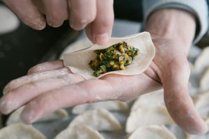 a hand holding a piece of food
