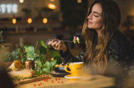 a woman sitting at a table in a restaurant