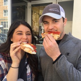 a woman eating a slice of pizza