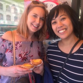 a woman holding a hot dog