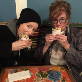 a person sitting at a table eating food