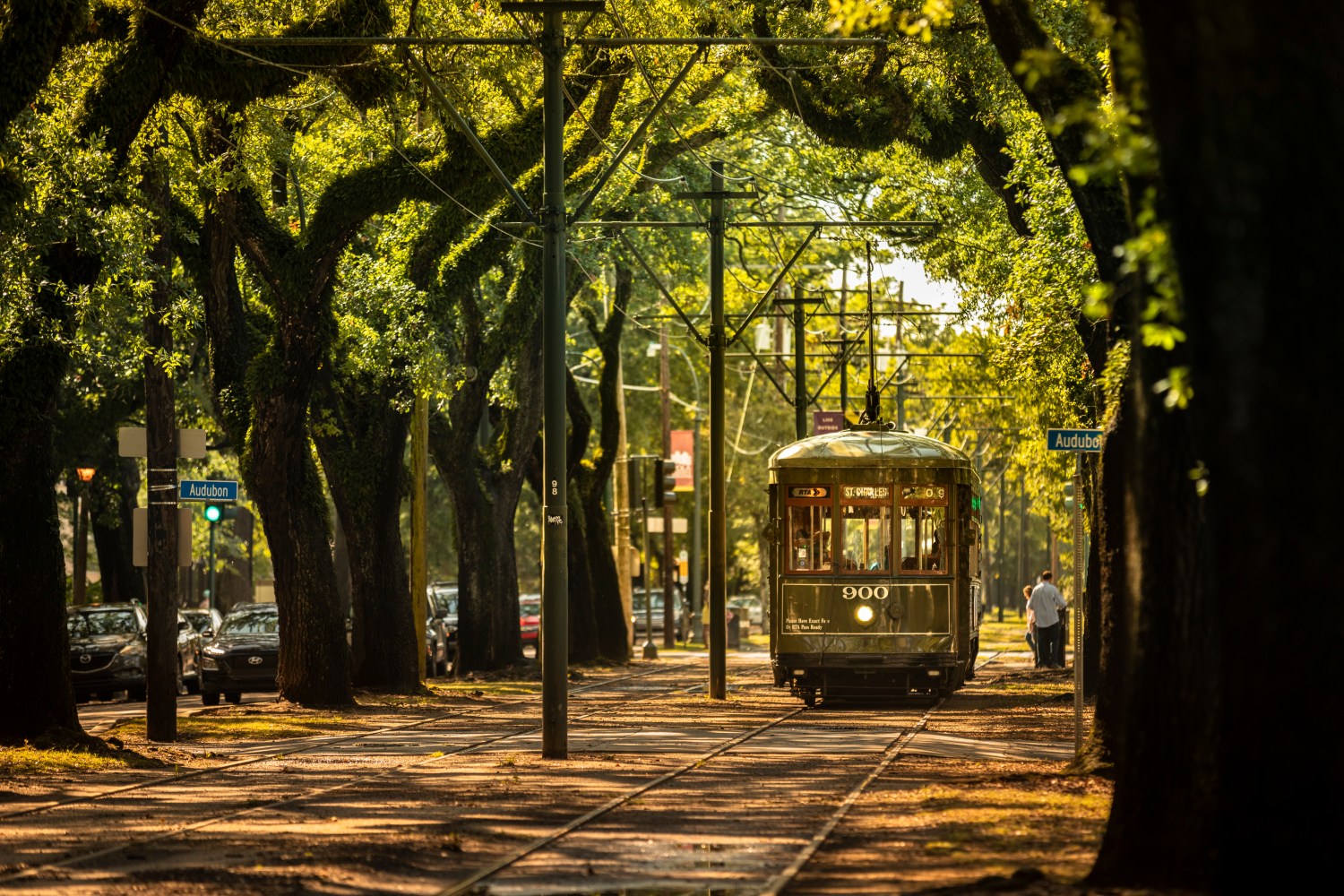 Passengers ride the historic railway streetcar along Saint Charles Avenue in the Garden District of New Orleans