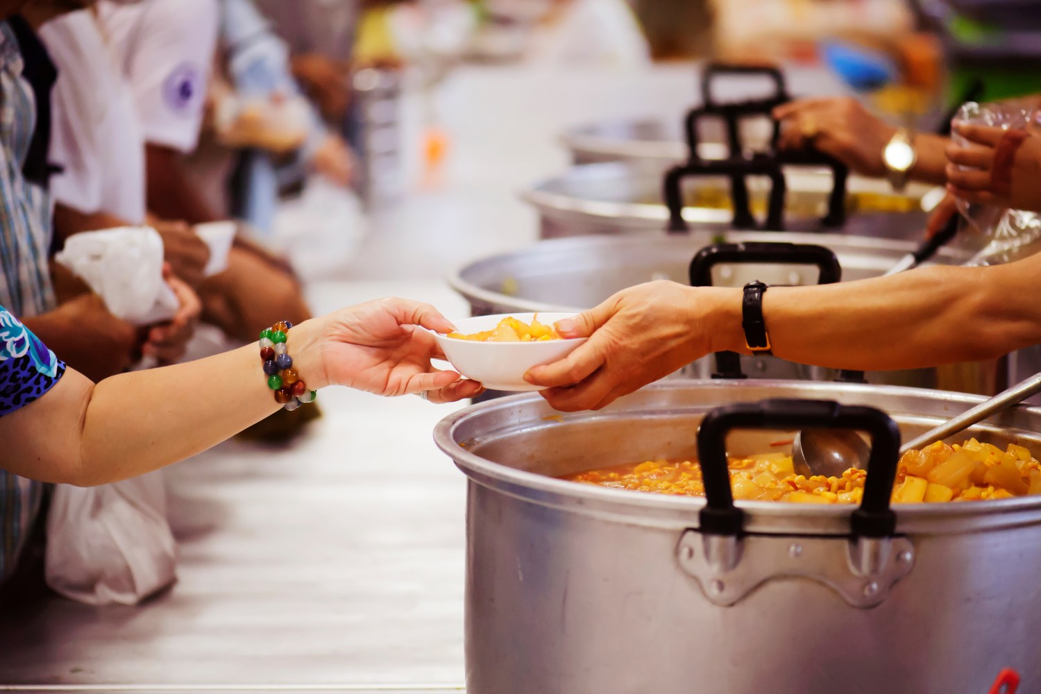 Someone handing food to another person