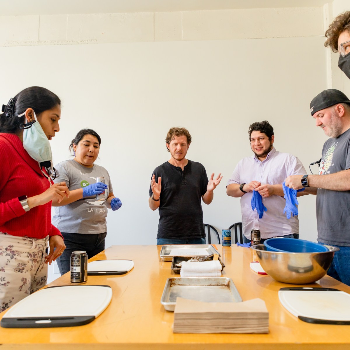 Coworkers assemble for a group cooking class