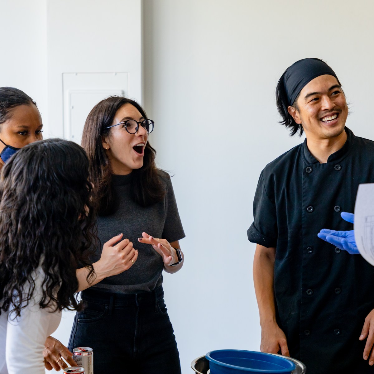 A group of colleagues has fun in a team building cooking class