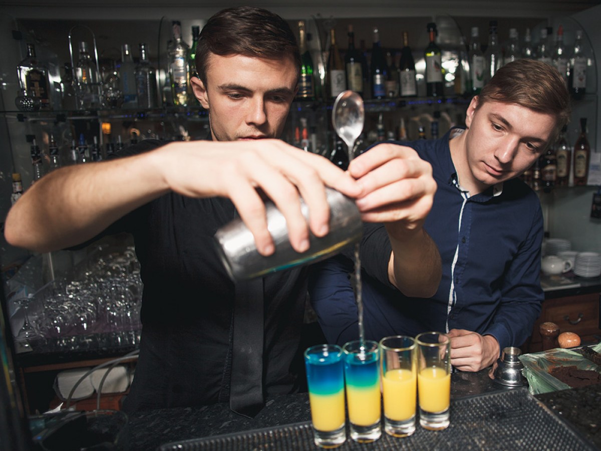 a man pouring mixed drinks at the bar in Nashville