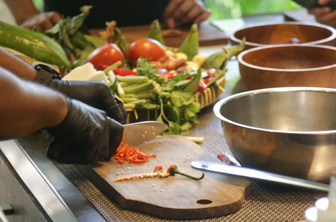 Chef dicing vegetables in the kitchen for a cooking class,