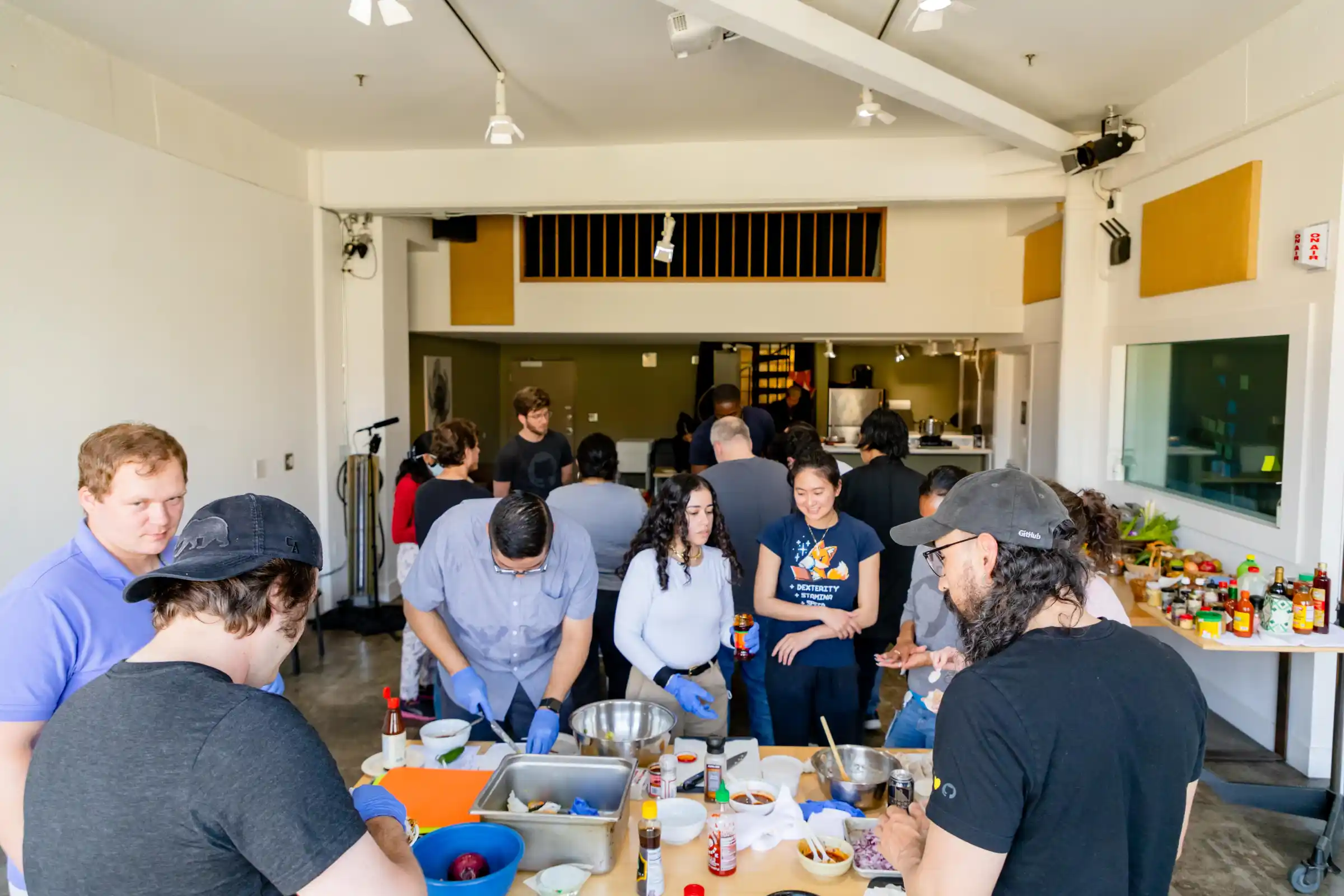 group_cooking_class_NYC_0173-min a group of people standing in a room