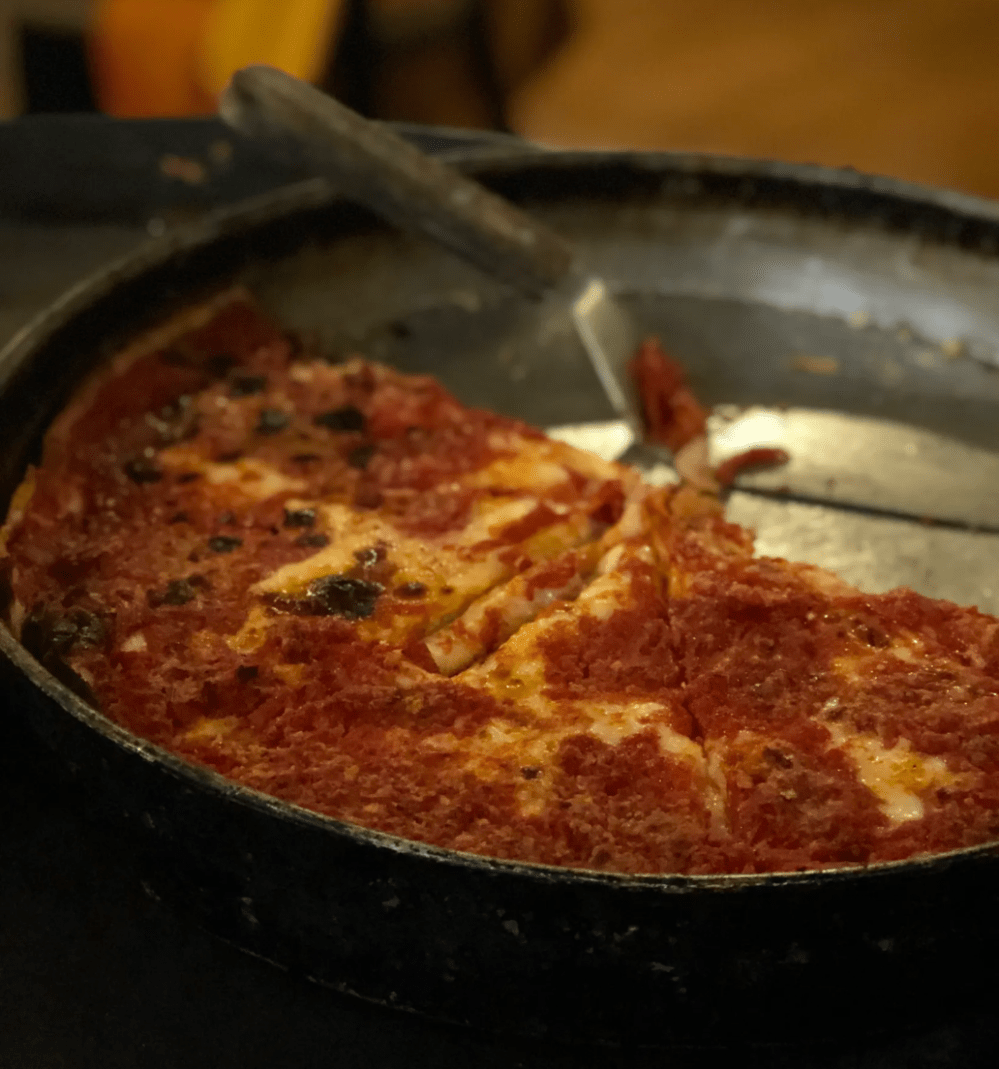 a pizza sitting on top of a pan