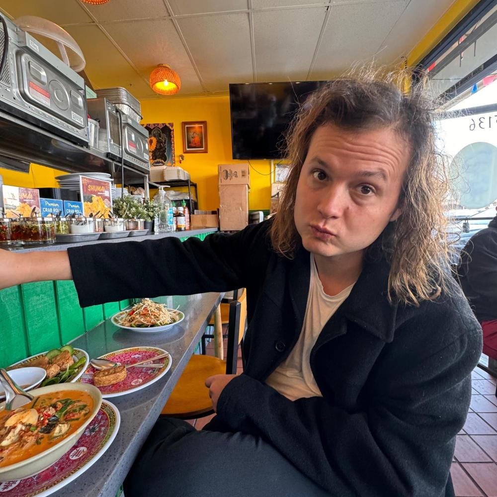 a person standing in front of a pizza