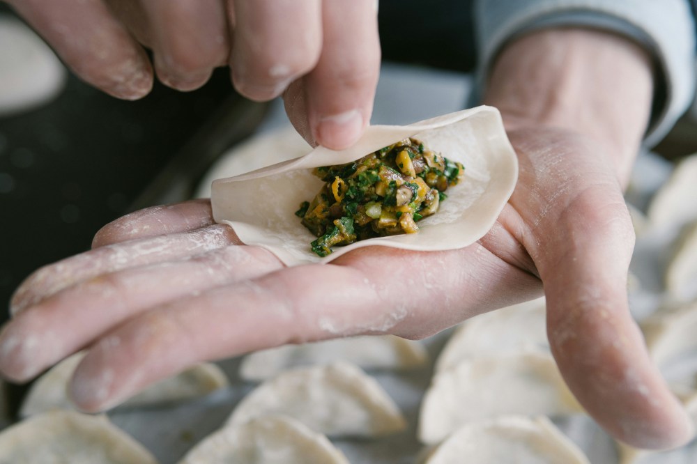 a hand holding a piece of food